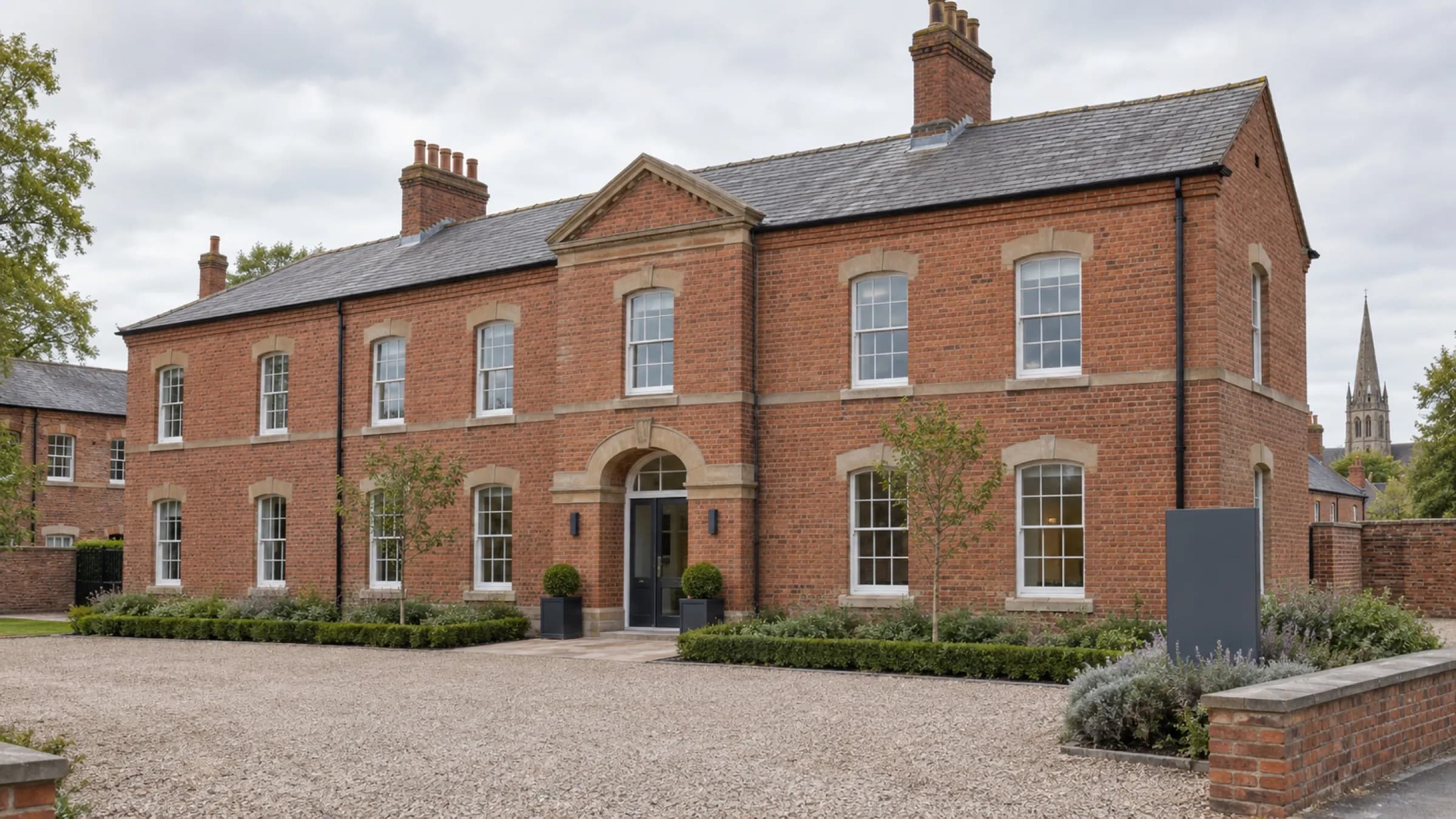 A converted red-brick barracks building in a Lincolnshire market town under soft overcast light